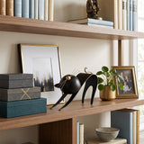 cat sculpture on bookshelf with boxes