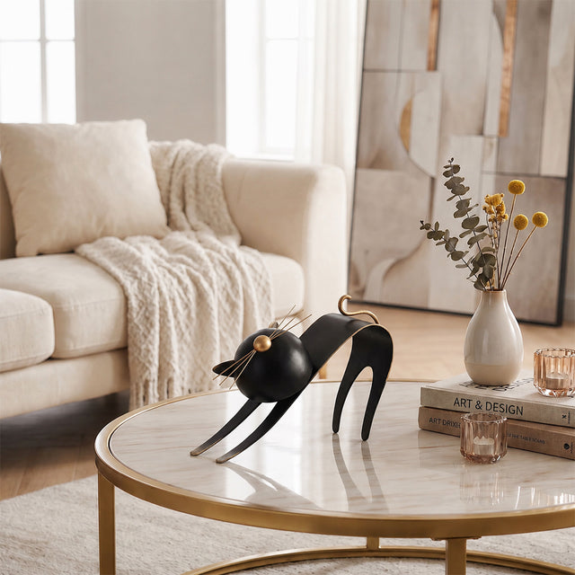 cat sculpture on marble coffee table