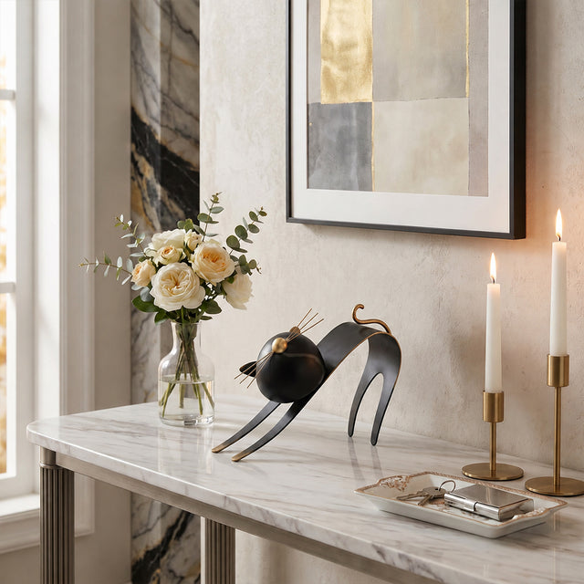 cat sculpture on marble console table