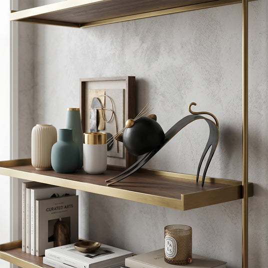 cat sculpture on wall shelf with vases