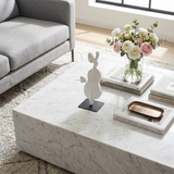 cello sculpture on marble coffee table