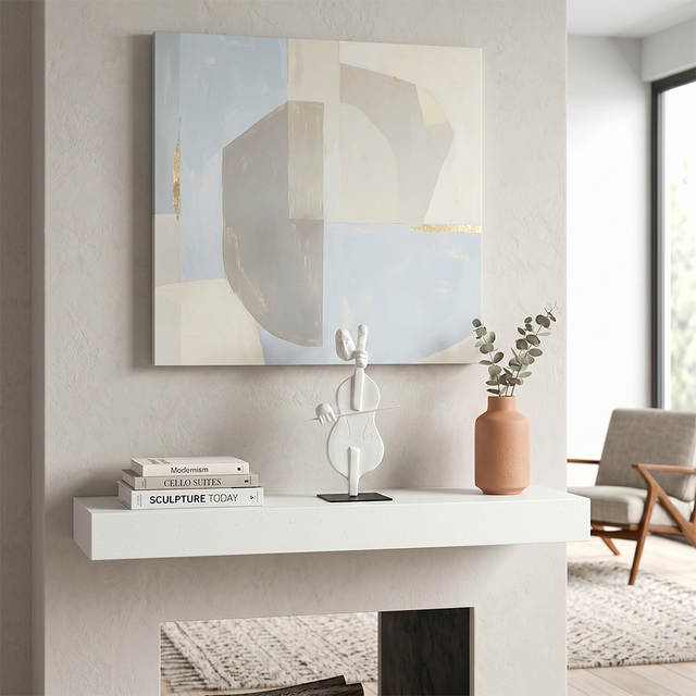 cello sculpture on white fireplace shelf