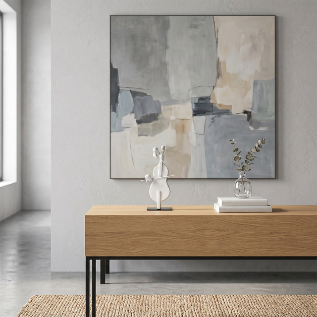 cello sculpture on wooden console under painting