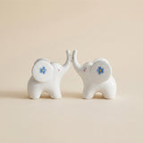 ceramic elephants touching trunks front view