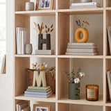 ceramic home letter vases on bookshelf with flowers