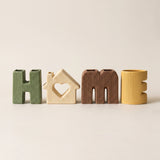 ceramic letter vases lineup on cream background