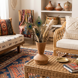 ceramic vase with peacock feathers in boho room