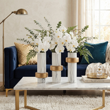 ceramic vases with orchids on living room coffee table