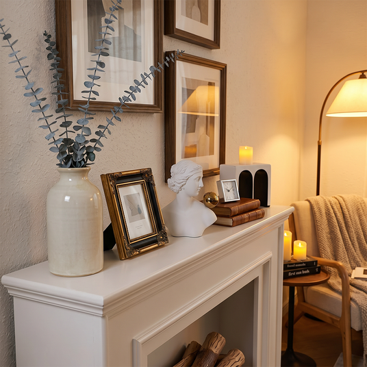 classical bust on fireplace mantel with frames