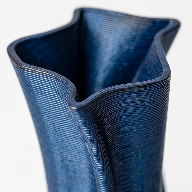 close up of blue twisted vase opening rim