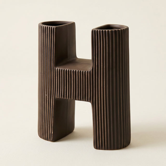 close up of brown ceramic letter h vase