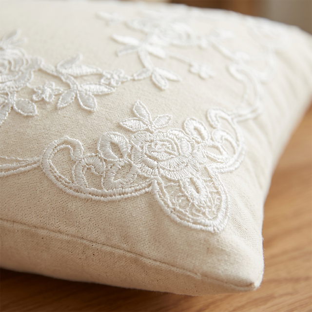 close up of cream embroidery vine and flower