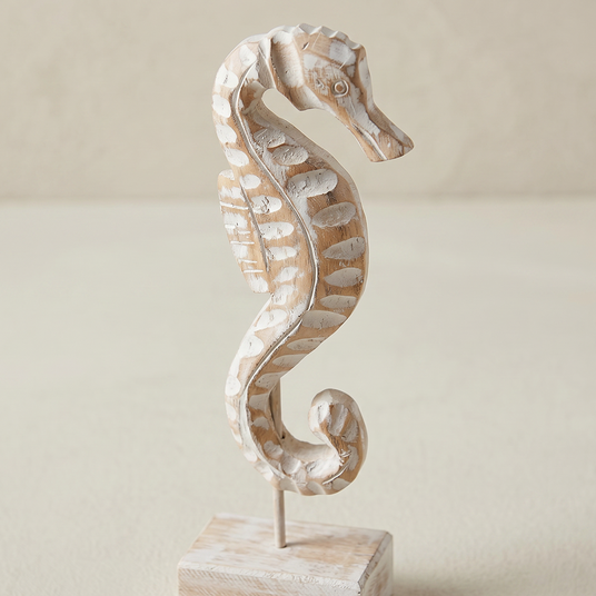 close up of distressed wood seahorse figurine