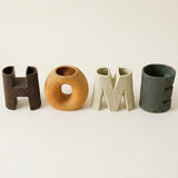 close up of four ceramic home letter vases