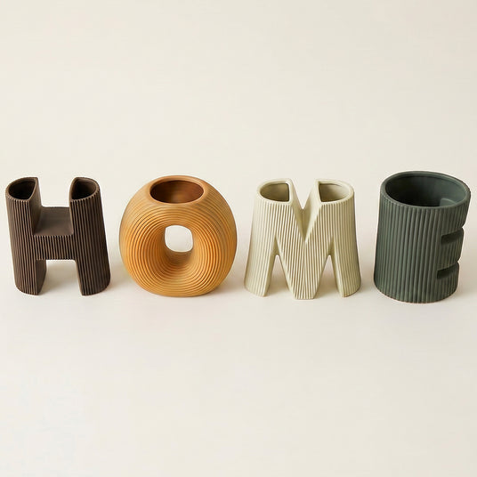 close up of four ceramic home letter vases