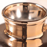 close up of glass vase opening and metallic rim