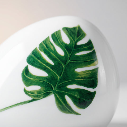 close up of monstera leaf print on ceramic