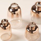 close up of rose gold glass vase metallic neck