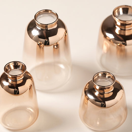 close up of rose gold glass vase metallic neck