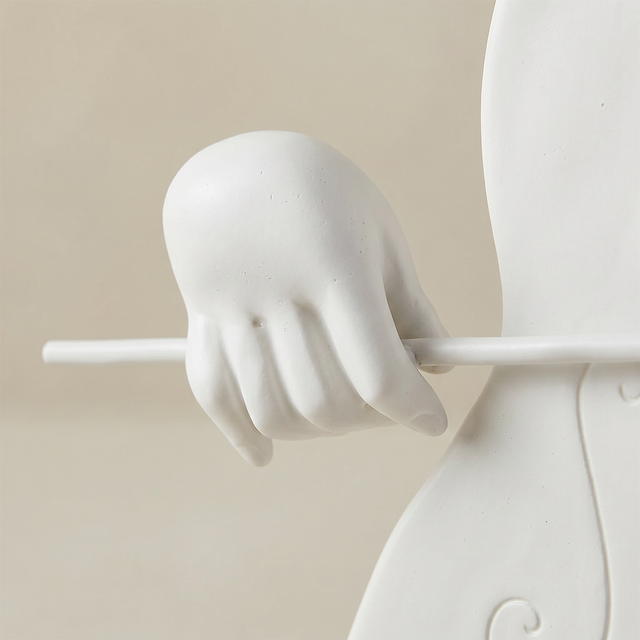 close up of sculpture hand holding bow