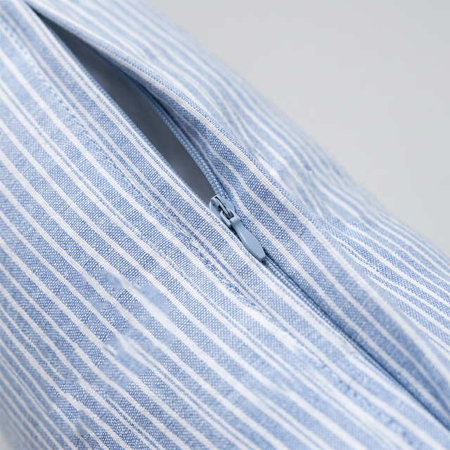 close up of striped pillow zipper detail