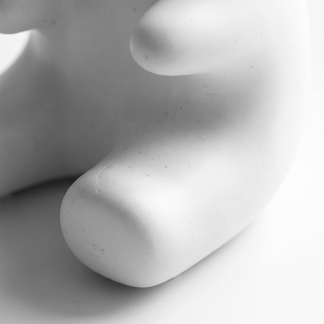 close up of white ceramic bear figurine base