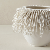 close up of white loop fringe vase rim