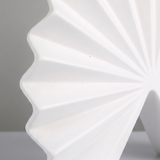 close up of white pleated vase folded lines