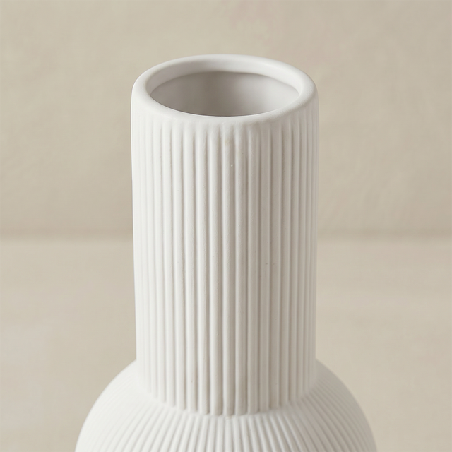 close up of white ribbed vase neck and rim