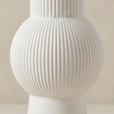 close up of white ribbed vase sphere body