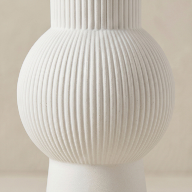 close up of white ribbed vase sphere body