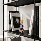 colorful crystal candle holder on black bookshelf