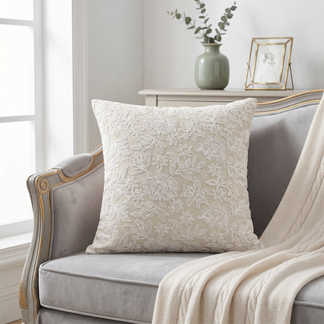 cream embroidered floral throw pillow on grey sofa