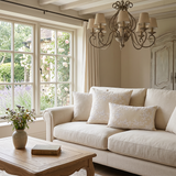 cream embroidered pillows on beige sofa with lavender