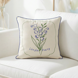 cream lily of valley embroidered pillow with blue piping