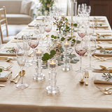 crystal candle holders on long gold dining table