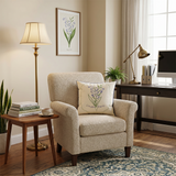 embroidered lily pillow on beige armchair with desk