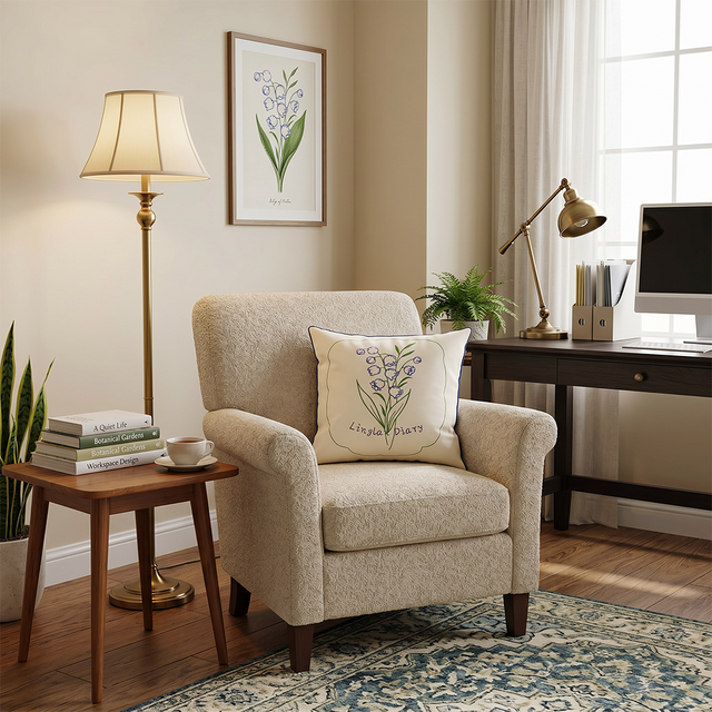 embroidered lily pillow on beige armchair with desk