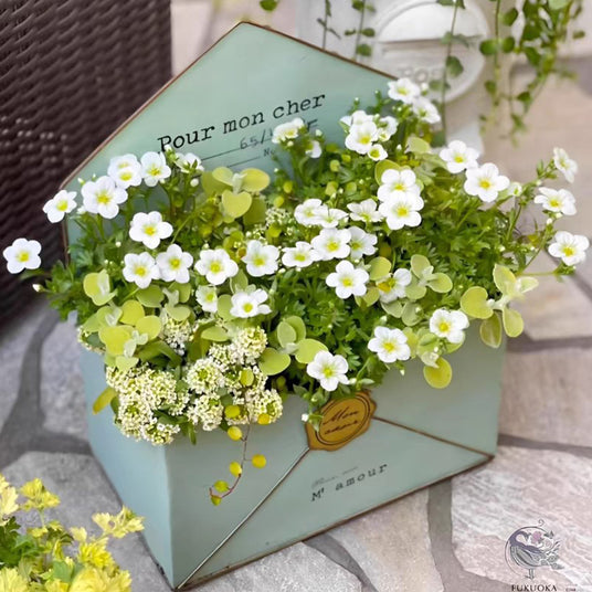 envelop shaped planter filled with flower