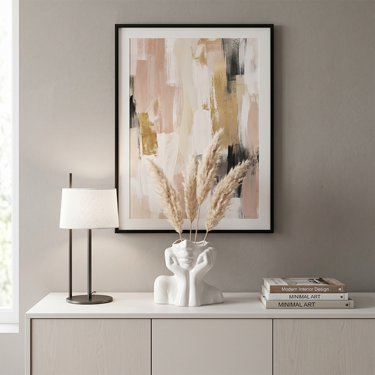 face vase with dried grass on sideboard under painting