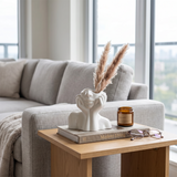 face vase with pampas grass on living room table