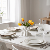 face vase with tulips on white dining table