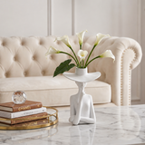 figure vase with calla lilies on marble table