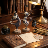 figurines standing cats on vintage desk letters