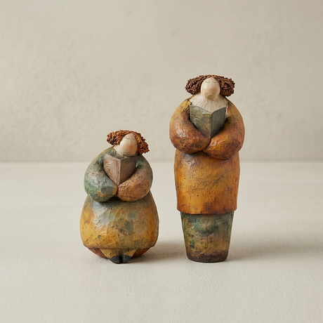 figurines two women holding books white