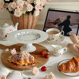 floral vine embossed ceramic serving cake stand on the dining table