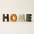 four letter ceramic home vases on beige
