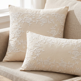 front view of cream embroidered floral pillows