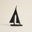 geometric sailboat sculpture on beige background