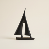 geometric sailboat sculpture on beige background